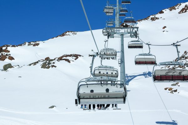 Winter mountains panorama with ski slopes and ski lifts. Alps. Austria. Pitztaler Gletscher. Wildspitzbahn Winter mountains panorama with ski slopes and ski lifts. Alps. Austria. Pitztaler Gletscher. Wildspitzbahn. Winter season